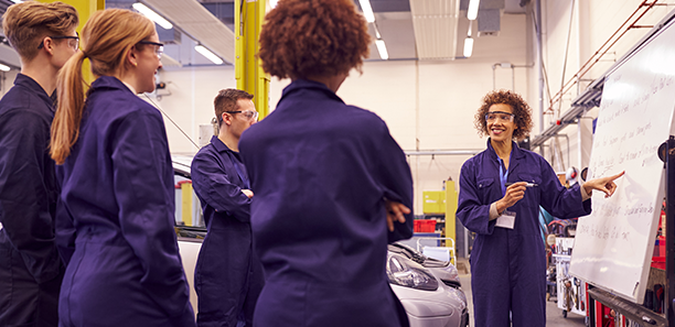 TAFE teacher guiding class through automotive repair