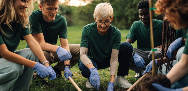 students and teacher plant a tree