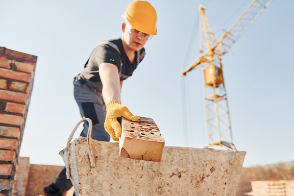 Tradie stacking bricks