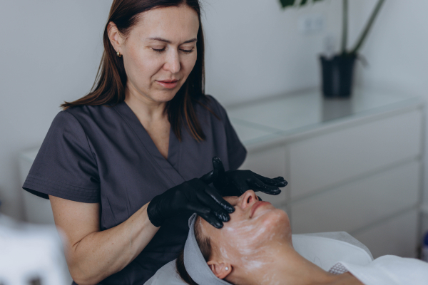 makeup artist applying skin cream