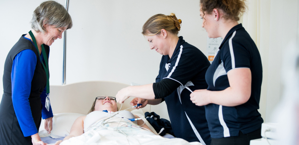 Nursing students examining patients