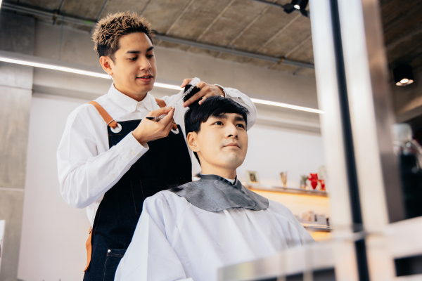 Barber cutting a customer's hair