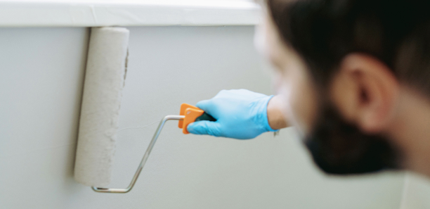 Painter using a roller on the wall