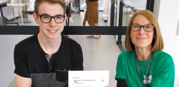 Early Childhood student receiving his ticket from staff member Claire