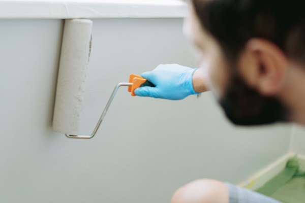 Painter using roller on a wall