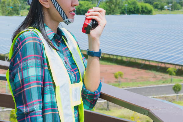 technician on walky talky at a solar farm