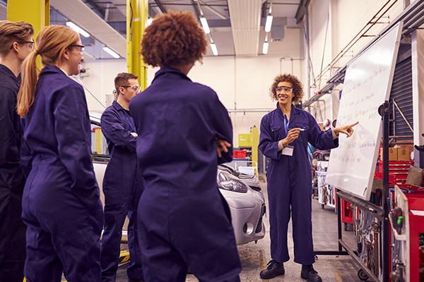 TAFE teacher guiding class through automotive repair